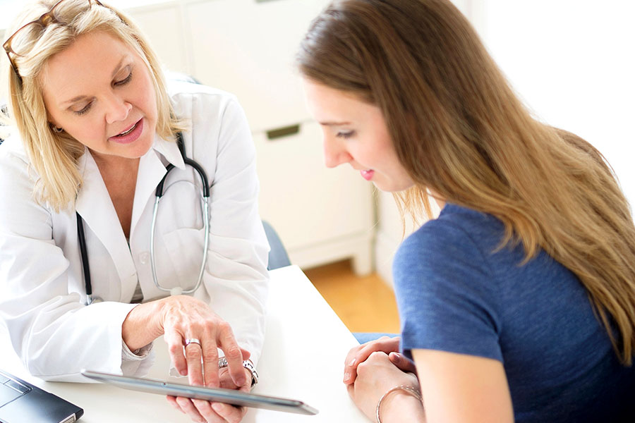 Doctor showing the scope included in the magellan rehab coverage to patient