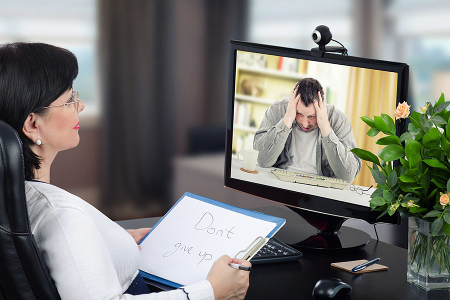 Doctor with patient suffering from mental health condition during telehealth session