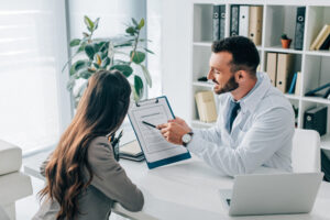 An addiction treatment specialist working with a woman who has a substance abuse issue about her personalized and comprehensive treatment program at Transformations Treatment Center