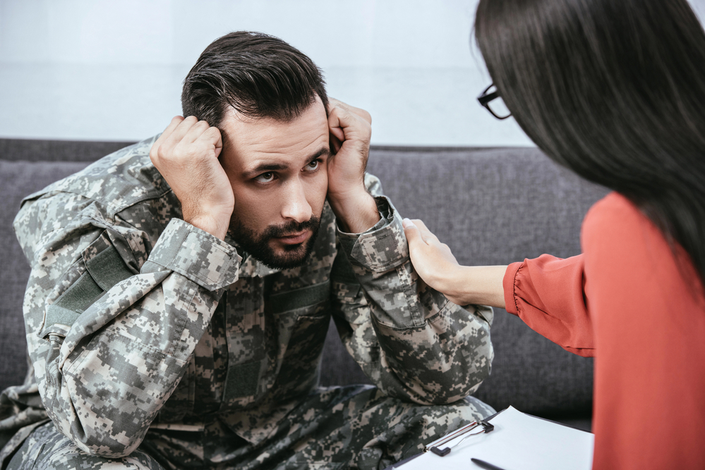 therapist helping veteran with PTSD to cope