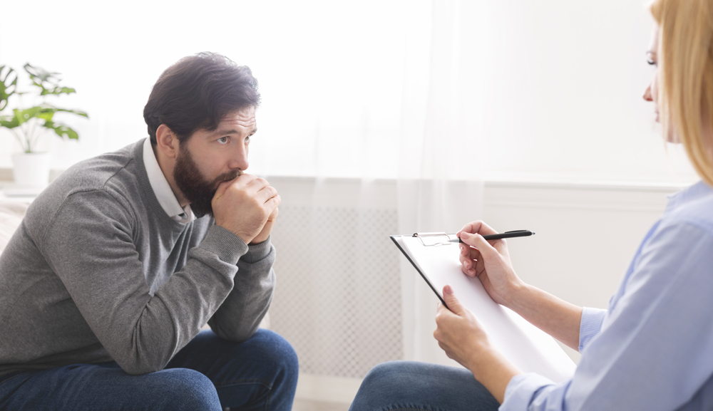 therapist explaining ComPsych mental health rehab coverage to patient