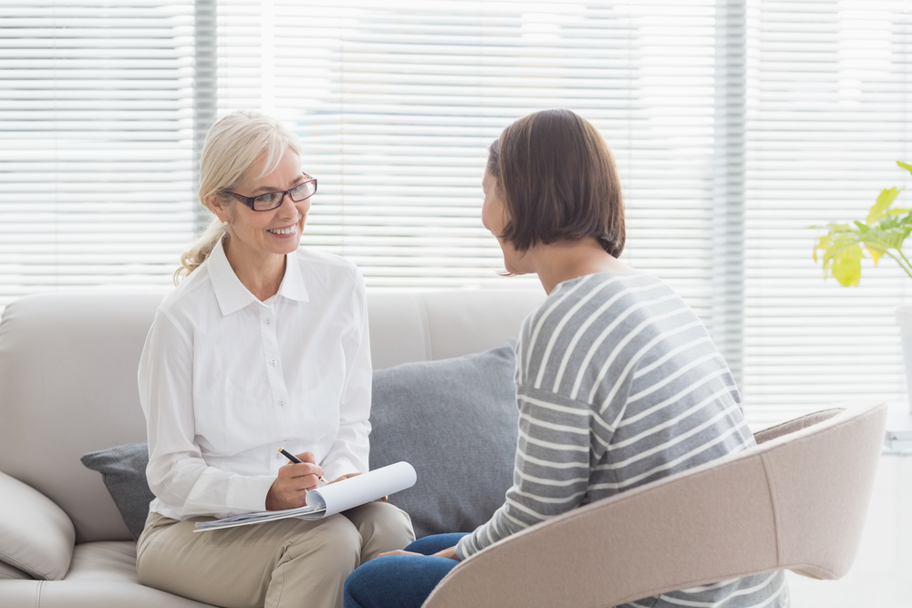 therapist explaining allied trades mental health rehab insurance to patient