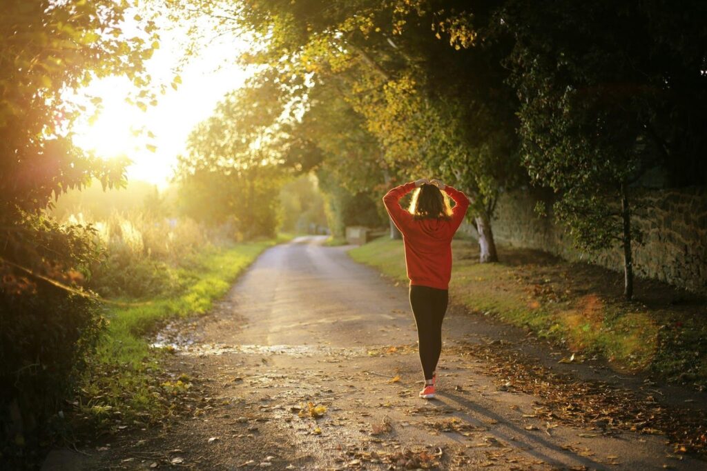 woman and veteran walking in the woods, showing how mental health and staying active are an important part of mental health treamtent, covered by Optum VA CCN mental health rehab insurance